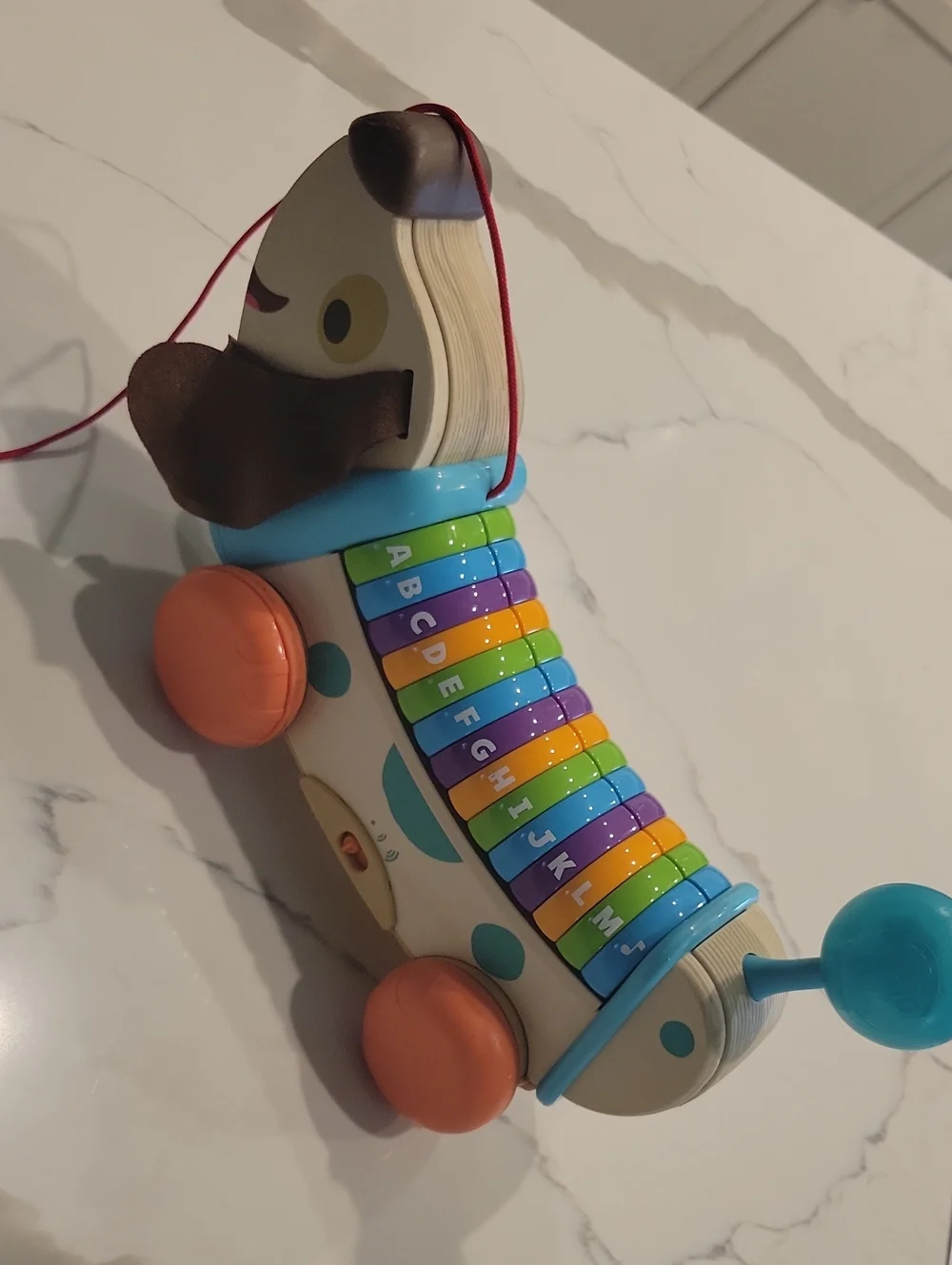 Leapfrpg Pull-Along Dog Xylophone Toy in Blue, Orange, Green